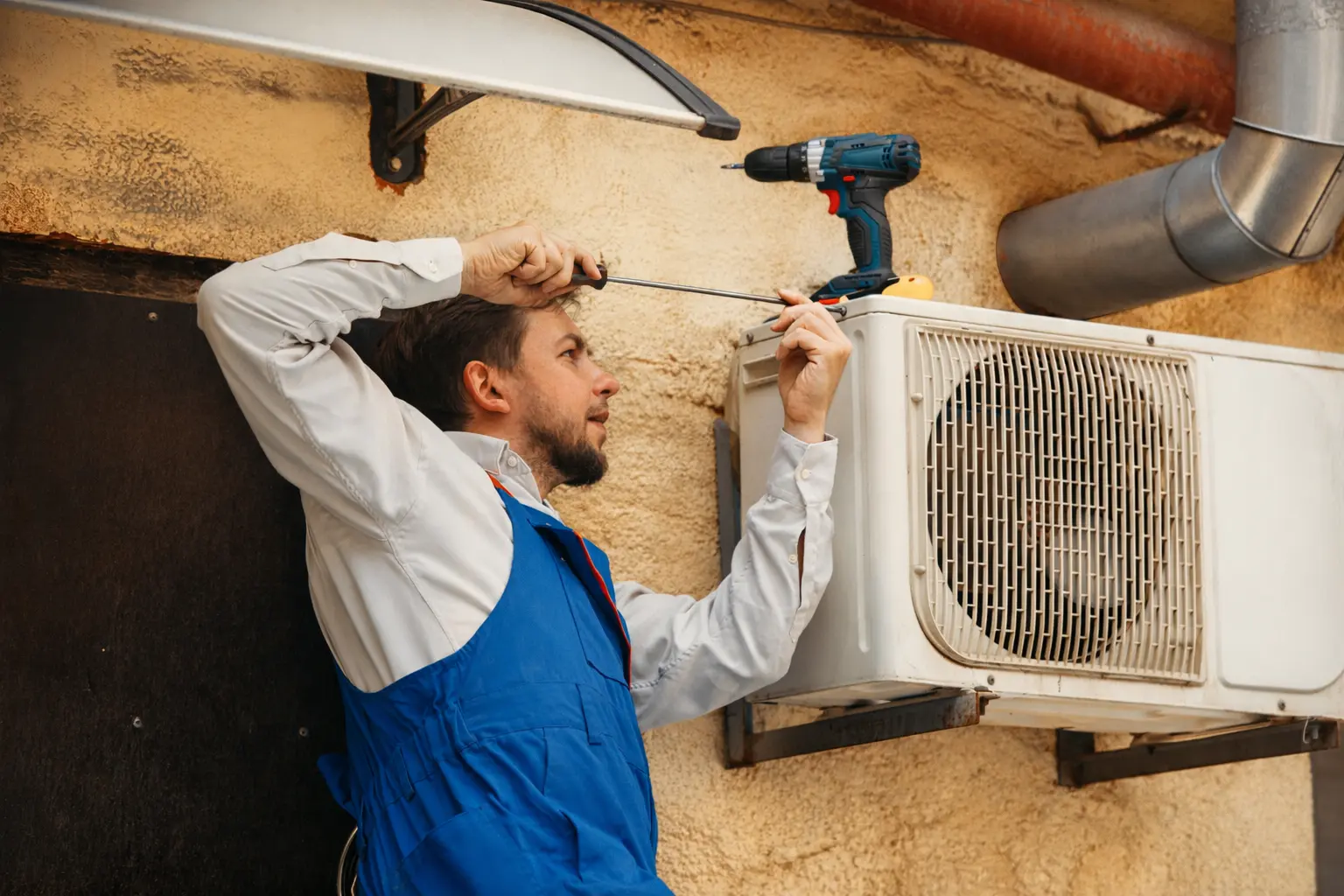 Man fixing outdoor unit